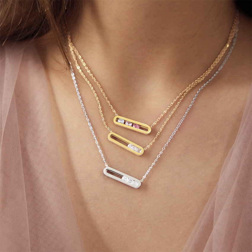 Gold and silver floating cubic zirconia bar necklaces worn in layered styling
