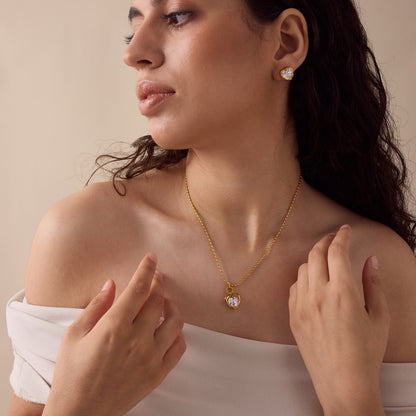 Model wearing gold heart zircon necklace and matching stud earrings