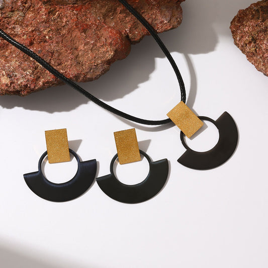 Matching stainless steel necklace and earring set in black and gold tone for gift shops and resale