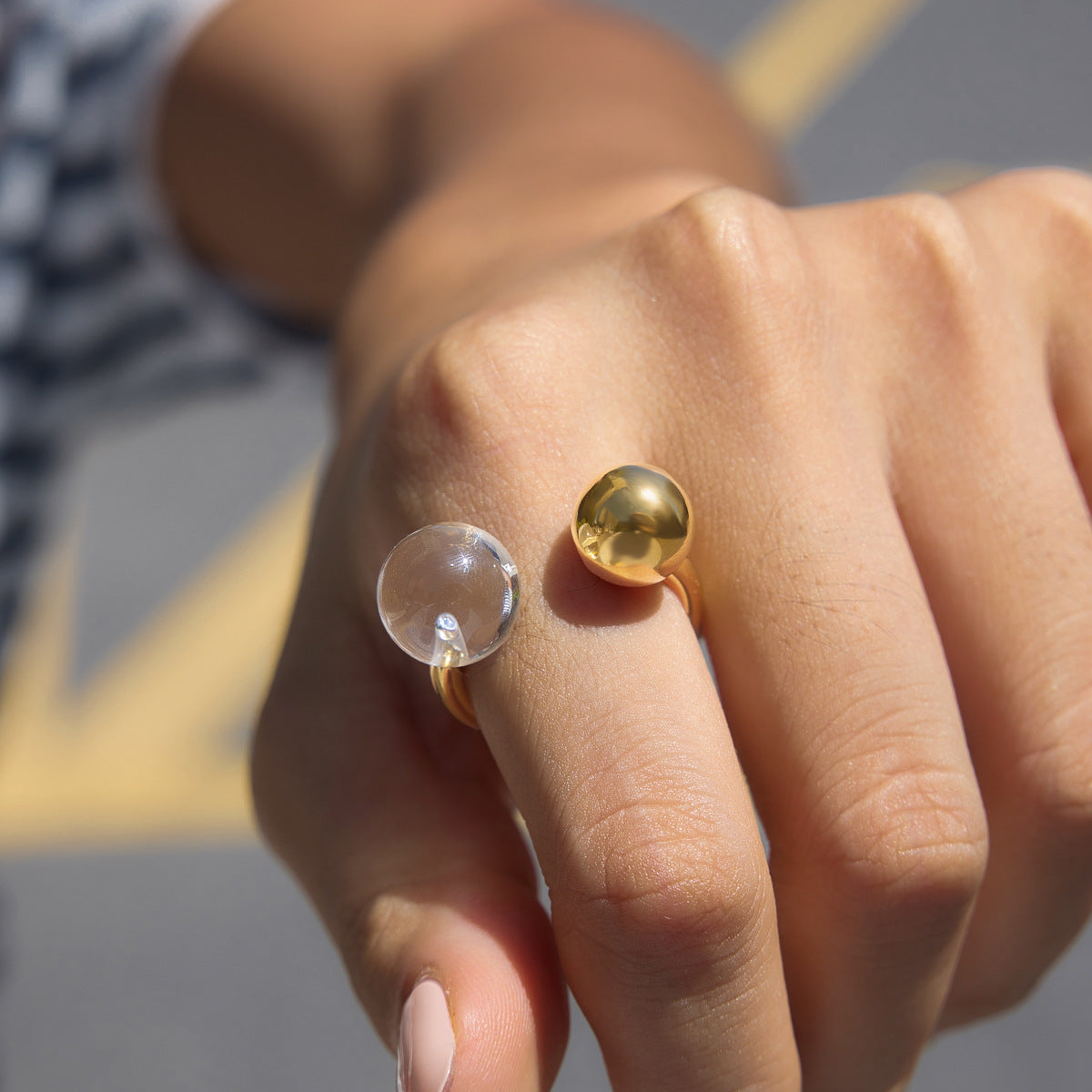 Sculptural stainless steel statement ring with contrasting clear and gold balls