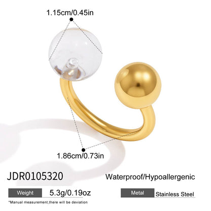 Gold tone stainless steel open ring with clear resin ball and size details