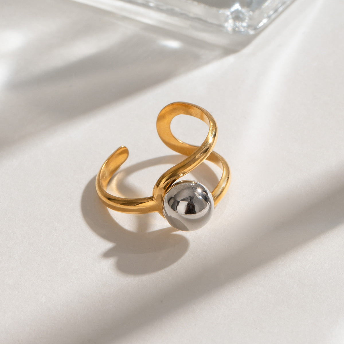 Wholesale stainless steel jewelry featuring 18K gold PVD coated open ring adjustable style with statement ball.