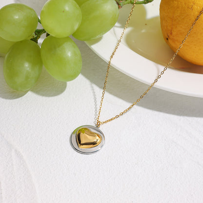 Model wearing wholesale stainless steel heart necklace layered with minimalist jewelry for women