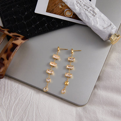 Gold zircon tassel earrings flat lay for wholesale display