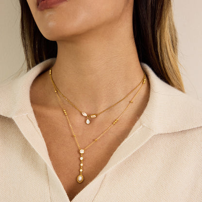 Model wearing stainless steel zircon pearl Y necklace for autumn styling