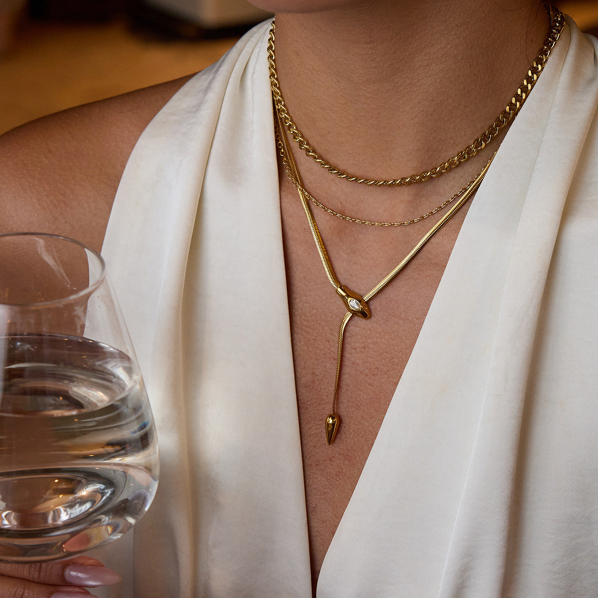 Model wearing 18K gold stainless steel snake Y necklace layered styling
